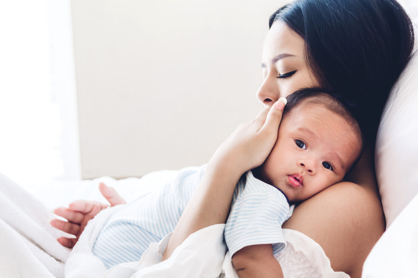 Mom holding new born on article which postpartum belt is the best